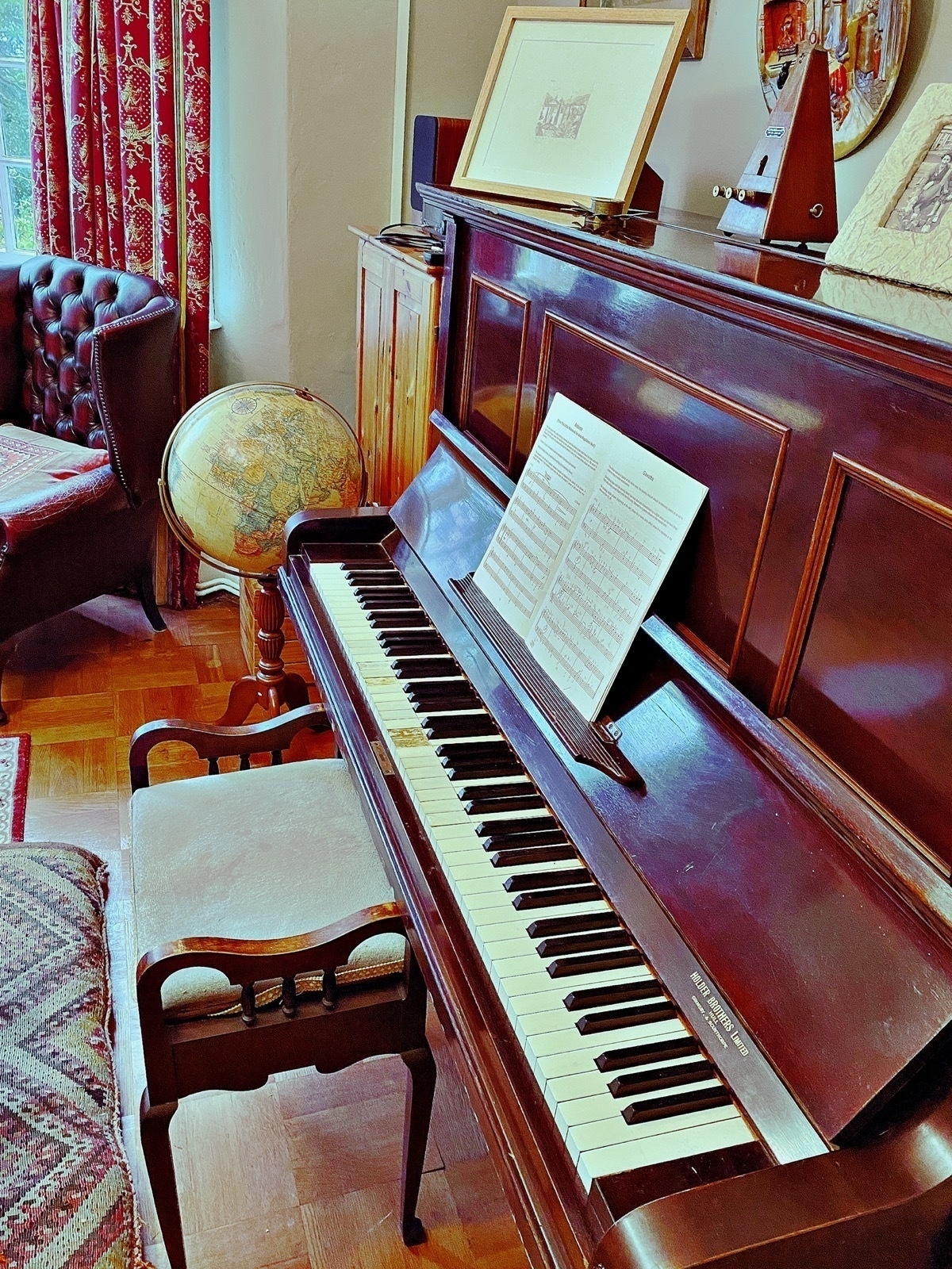 Upright piano with sheet music propped above the keys